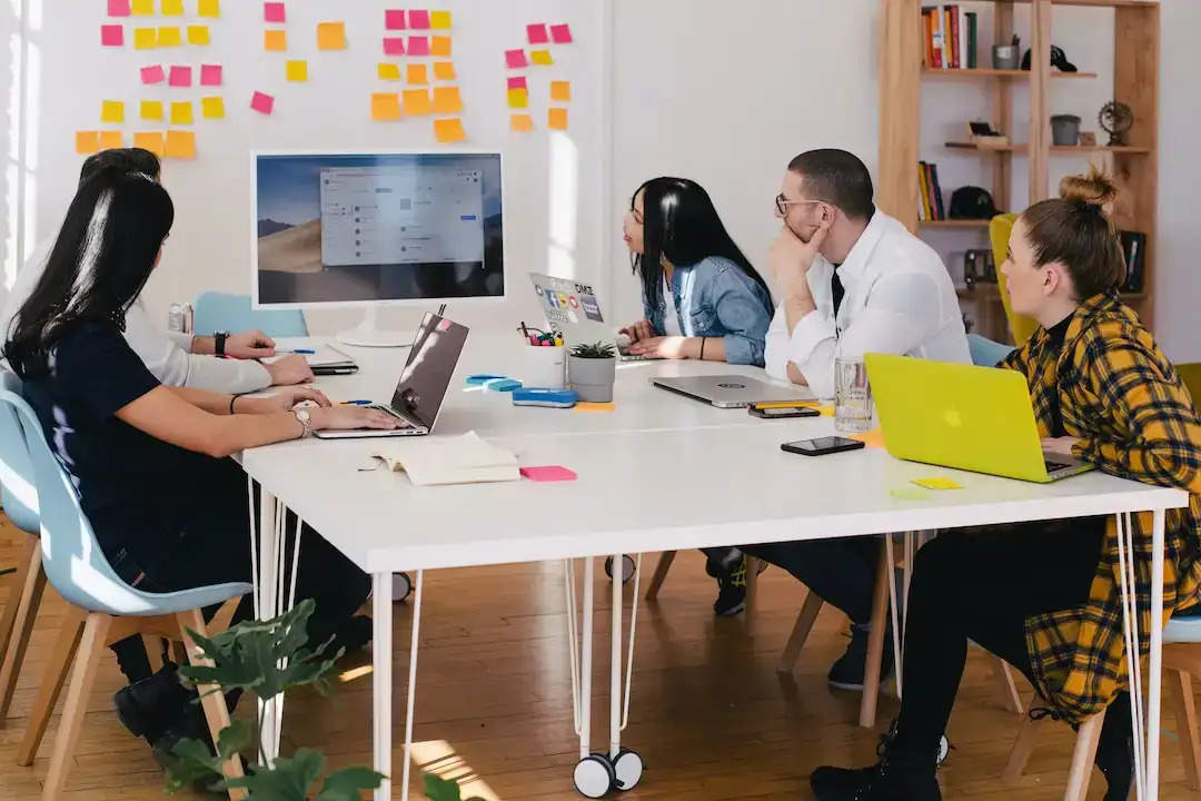  A team in an office discussing knowledge management systems during a meeting